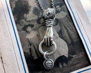 hand holding charm holder