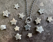 tiny star fossil pendant