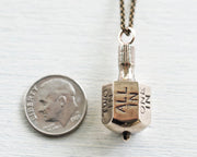Put and Take spinner game necklace pendant