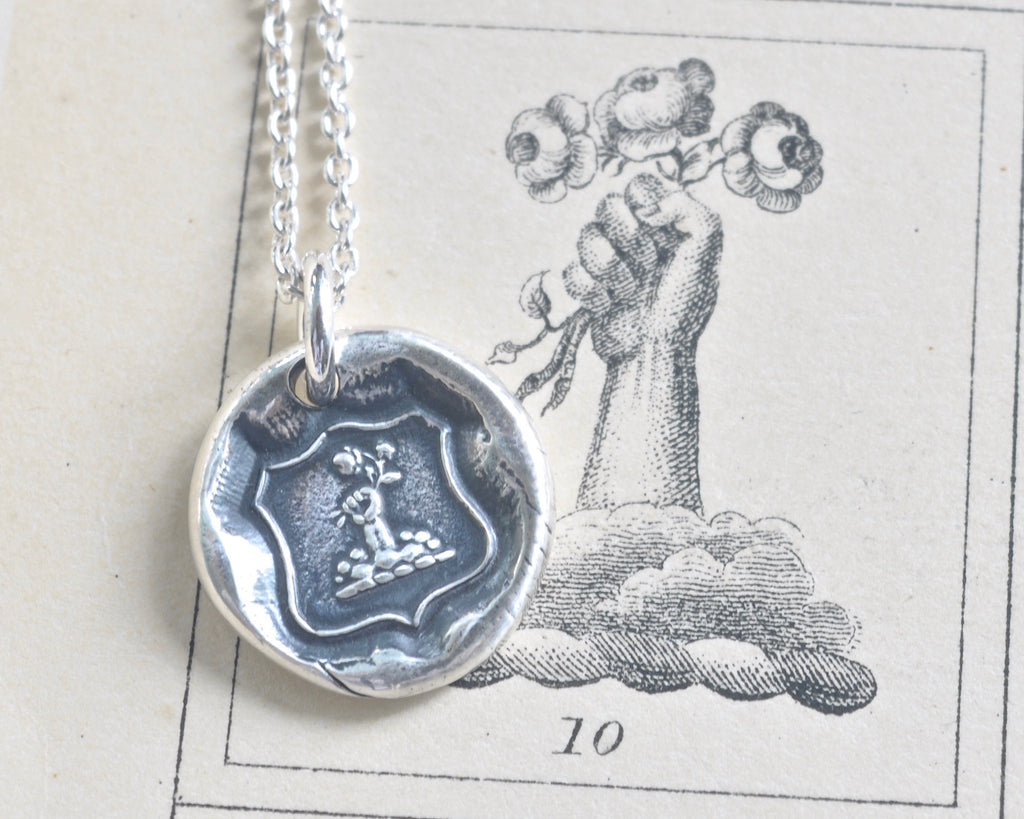 fist and flowers wax seal necklace