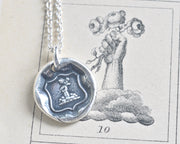 fist and flowers wax seal necklace