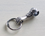 hand holding ouroboros charm holder necklace