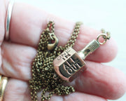 Put and Take spinner game necklace pendant