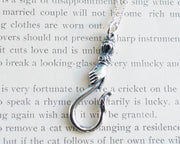 hand holding serpent hook