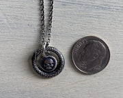 skull surrounded by ouroboros jewelry