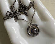 ouroboros surrounding skull necklace