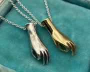 gold figural hand necklace