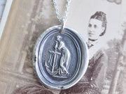woman leaning on anchor wax seal necklace