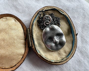 haunted doll face charm