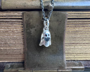 ghost holding a heart pendant