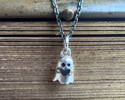 ghost holding a heart jewelry