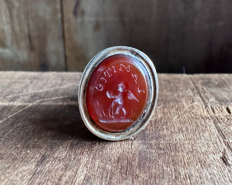 a winged cherub delivering a heart fob seal - L'AMITIE - antique wax seal