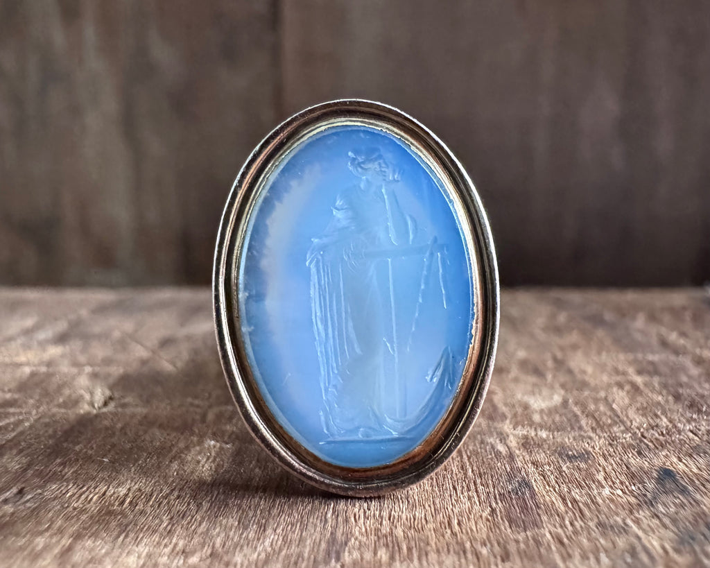 woman leaning on an anchor wax seal fob - antique wax seal