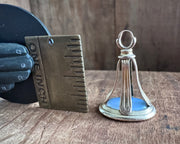 woman leaning on an anchor wax seal fob - antique wax seal