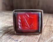 a little bird resting on an anchor leaning against a rock - antique fob wax seal