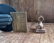 a little bird resting on an anchor leaning against a rock - antique fob wax seal