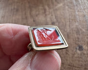 a little bird resting on an anchor leaning against a rock - antique fob wax seal