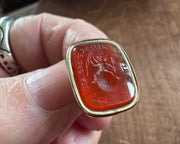 a winged cherub on top of the world fob seal - I RIDE TRIUMPHANT