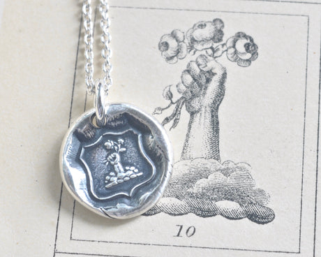fist and flowers wax seal necklace