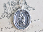 woman leaning on anchor wax seal necklace