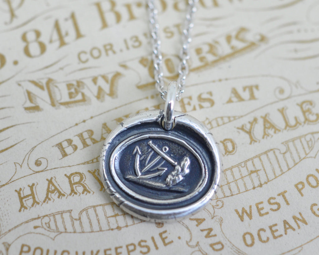 anchor leaning on a rock wax seal necklace