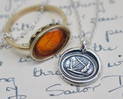 anchor leaning on a rock wax seal pendant