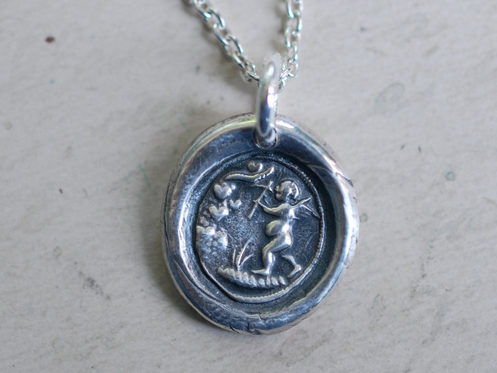 cupid mining a heart wax seal necklace